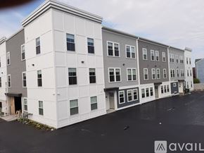 Lowell apartment for rent - A building with the word AVAILABLE on the bottom right corner.