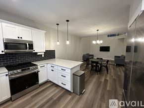 Lehi apartment for rent - A kitchen with white cabinets and black countertops.