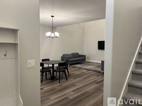 Lehi apartment for rent - A living room with a grey couch, a black table, and a wooden floor.