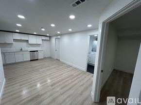 Lehi townhouse for rent - A spacious room with wooden flooring and white walls.