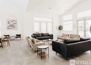 Lehi townhouse for rent - A modern living room with a black leather sofa and wooden furniture.