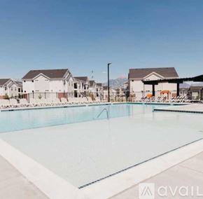 Lehi townhouse for rent - A large swimming pool in front of a row of houses.