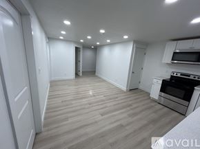 Lehi townhouse for rent - A spacious kitchen with wooden flooring and white cabinetry.