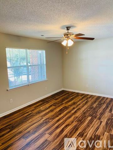 Greenville apartment for rent - A kitchen with wooden cabinets and a white dishwasher.