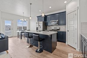 Lehi apartment for rent - A modern kitchen with a bar stool and a view of the outdoors.