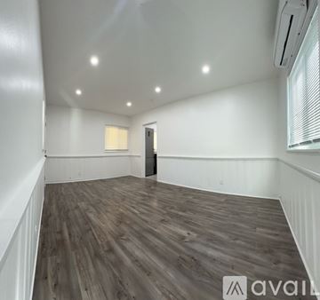 Burbank apartment for rent - A modern kitchen with a stainless steel refrigerator and black cabinets.