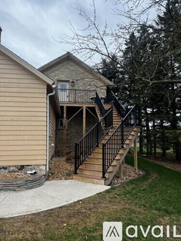 Kewaskum apartment for rent - A kitchen with white cabinets and a black fan.