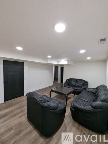 Cedar City apartment for rent - A living room with black furniture and a wooden floor.