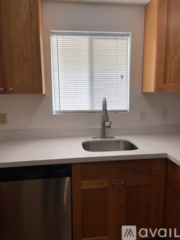 Lynnwood apartment for rent - A kitchen with wooden cabinets and a stainless steel dishwasher.