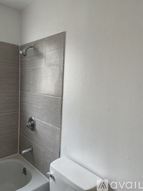 Lynnwood apartment for rent - A bathroom with a white toilet and a tiled shower.