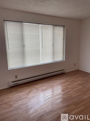 Lynnwood apartment for rent - A room with wooden flooring and a window with blinds.