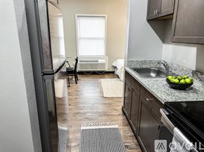 Rolla apartment for rent - A kitchen with a black fridge, black oven, and a black chair.