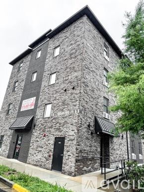 Rolla apartment for rent - A grey stone building with a black awning and a sign that says "The Ship".