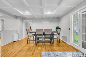 Murfreesboro house for rent - A dining room with a wooden floor and a white ceiling.