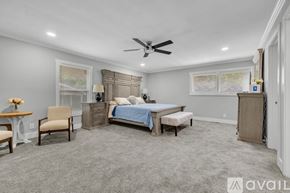 Murfreesboro house for rent - A bedroom with a bed, dresser, and chair.