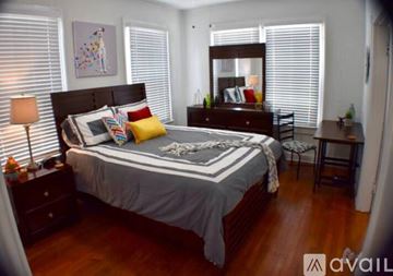 Tampa apartment for rent - A bedroom with a large bed and a wooden dresser.