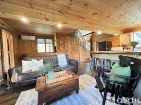 Thompsonville house for rent - A living room with a wooden ceiling and a staircase.