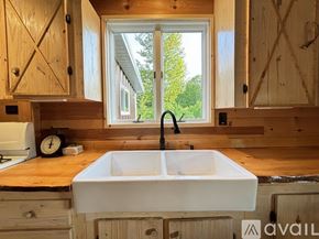 Thompsonville house for rent - A white sink is in a wooden cabinet in a kitchen.