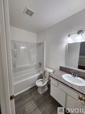 Bakersfield apartment for rent - A bathroom with a toilet, sink, and bathtub.