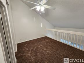 Bakersfield apartment for rent - A room with a ceiling fan and carpeted floor.