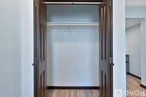 Houston apartment for rent - A white wall with a brown door and a white light switch.