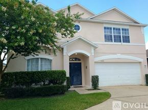 Orlando house for rent - A house with a blue door and a white garage door.
