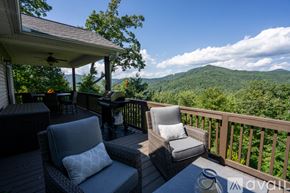 Clayton house for rent - A balcony with two chairs and a table overlooking a mountainous landscape.