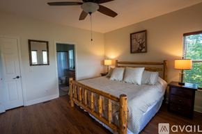 Clayton house for rent - A bedroom with a bed, dresser, and window.