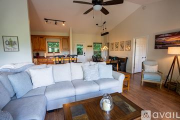 Clayton house for rent - A living room with a grey couch and a wooden coffee table.