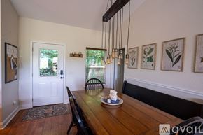 Clayton house for rent - A dining room with a wooden table and chairs.