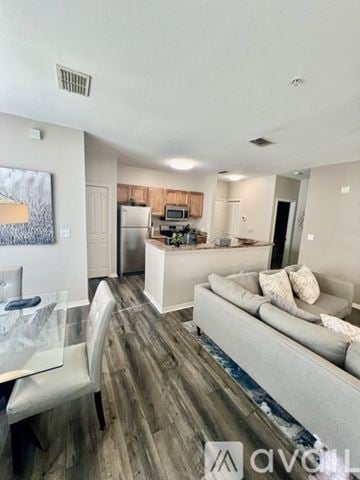 Sarasota apartment for rent - A modern living room with a grey couch and a wooden floor.