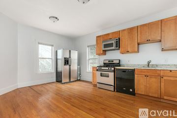 Somerville apartment for rent - A kitchen with wooden cabinets and stainless steel appliances.