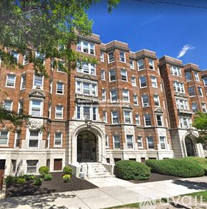 Boston apartment for rent - A large red brick building with a sign that says Boston Property Estate.