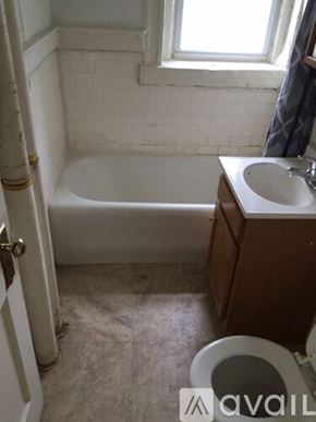 Boston apartment for rent - A bathroom with a toilet, sink, and bathtub.