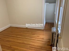 Boston apartment for rent - A room with wooden flooring and a wall-mounted air conditioning unit.