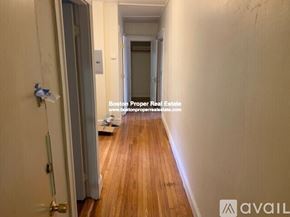 Boston apartment for rent - A hallway with wooden floors and white walls.