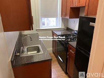 Boston apartment for rent - A kitchen with a sink and a refrigerator.