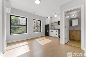 Chicago apartment for rent - A spacious kitchen with a refrigerator, cabinets, and a countertop is visible.