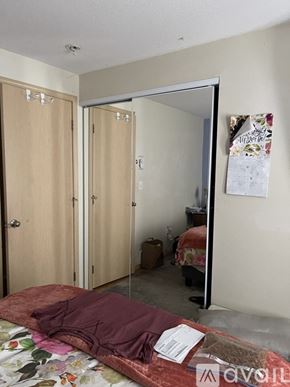 Jacksonville apartment for rent - A bedroom with a bed, a wardrobe, and a mirror.
