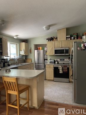 Jacksonville apartment for rent - A kitchen with a refrigerator, oven, and microwave.