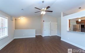 Greenville apartment for rent - A room with a ceiling fan and two windows.