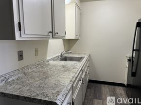 Salem apartment for rent - A kitchen with a granite countertop and white cabinets.