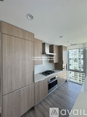 Chicago apartment for rent - A modern kitchen with wooden cabinets and a stove top oven.