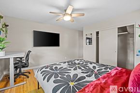 Albuquerque apartment for rent - A bedroom with a bed, desk, and a ceiling fan.
