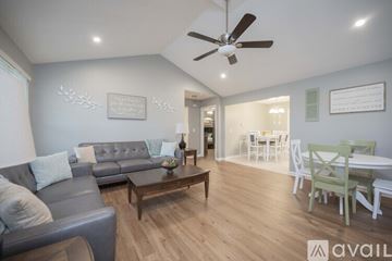 Murfreesboro house for rent - A living room with a grey couch and a wooden coffee table.