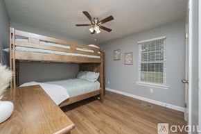 Murfreesboro house for rent - A bedroom with a bunk bed and a ceiling fan.
