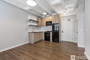 Chicago apartment for rent - A kitchen with wooden floors and white walls.