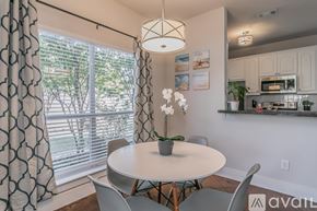 Fort Worth house for rent - A dining room with a table, chairs, and a plant.