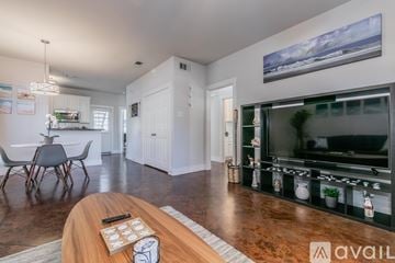 Fort Worth house for rent - A modern living room with a wooden coffee table in the foreground.
