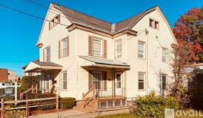 Glens Falls apartment for rent - A two-story house with a front porch is for sale.
